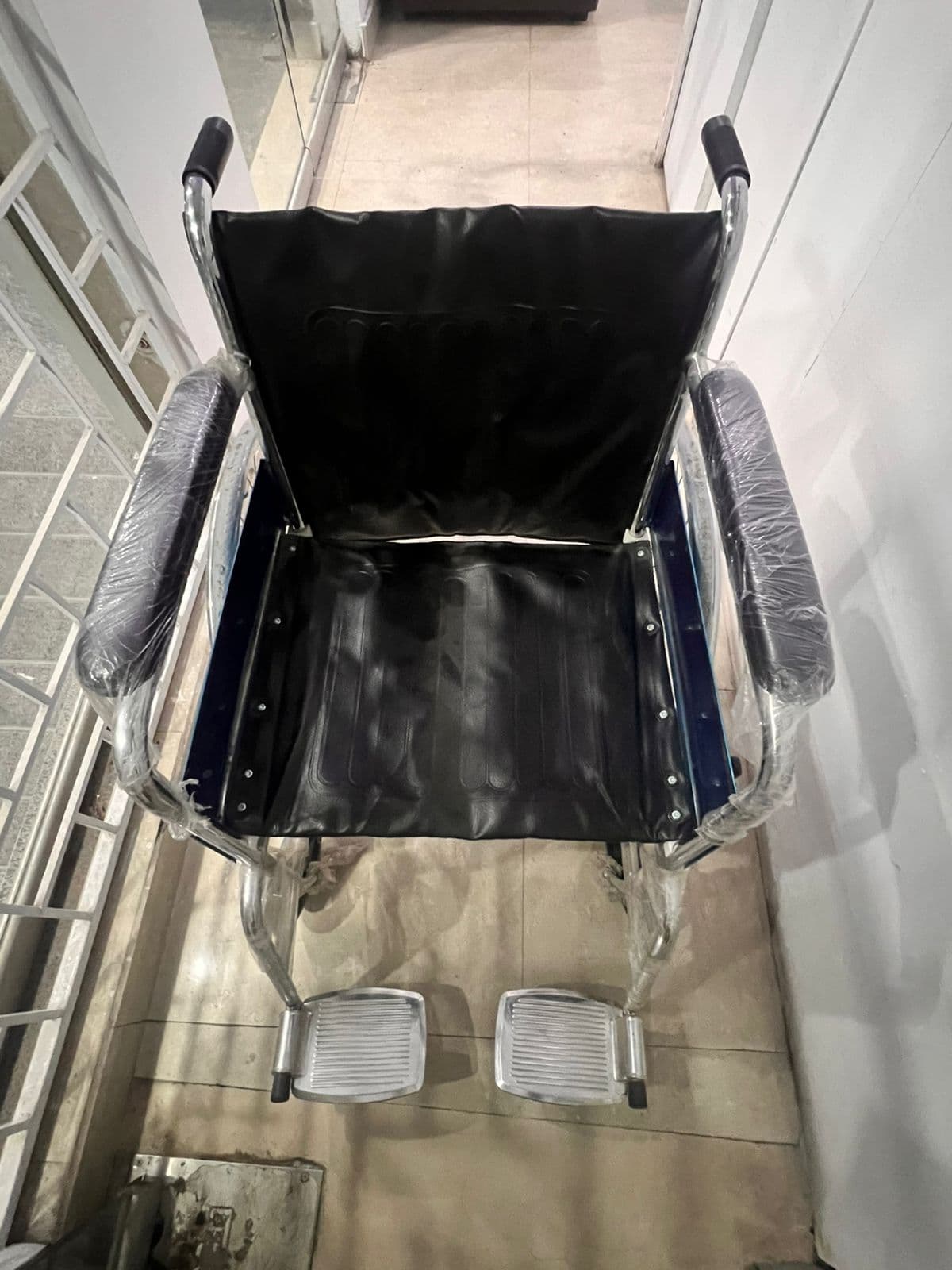 Wheelchair in the clinic corridor for older patients and mobility support