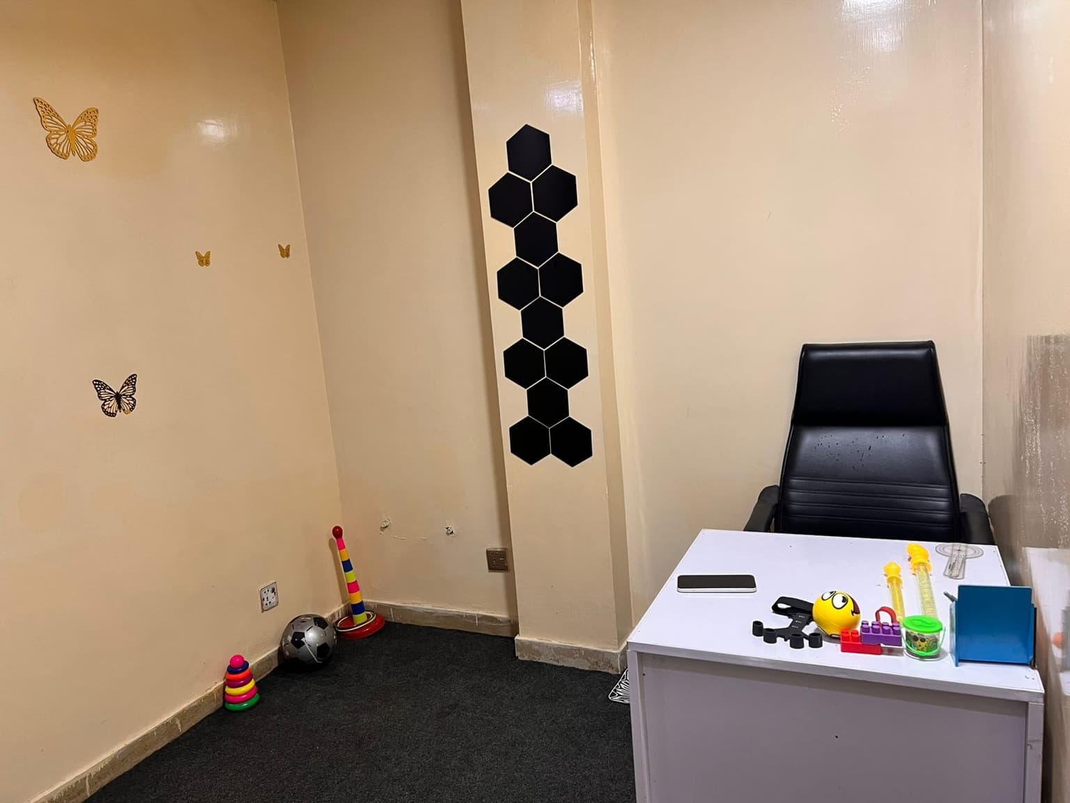 Paediatric physiotherapy room with toys, assessment tools, and a child-friendly desk